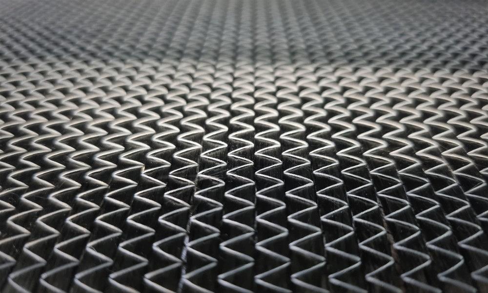 Carbon fiber reinforced plastic (CFRP) – structural detail in series production Macro shot of a CFRP surface showing the characteristic carbon fiber pattern