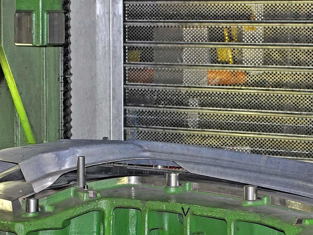 Hot forming of prototype components – high-temperature forming process Prototype part during hot forming on a forming tool in the manufacturing process